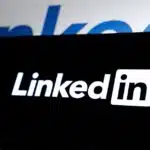 The LinkedIn logo displayed on a black screen with a blurred LinkedIn logo in the background.