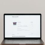 Laptop screen displaying an online checkout page for a MacBook Pro with product and price details.