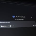 A computer screen displays a chat window with the text “Hi, I’m DeepSeek. How can I help you today?”.